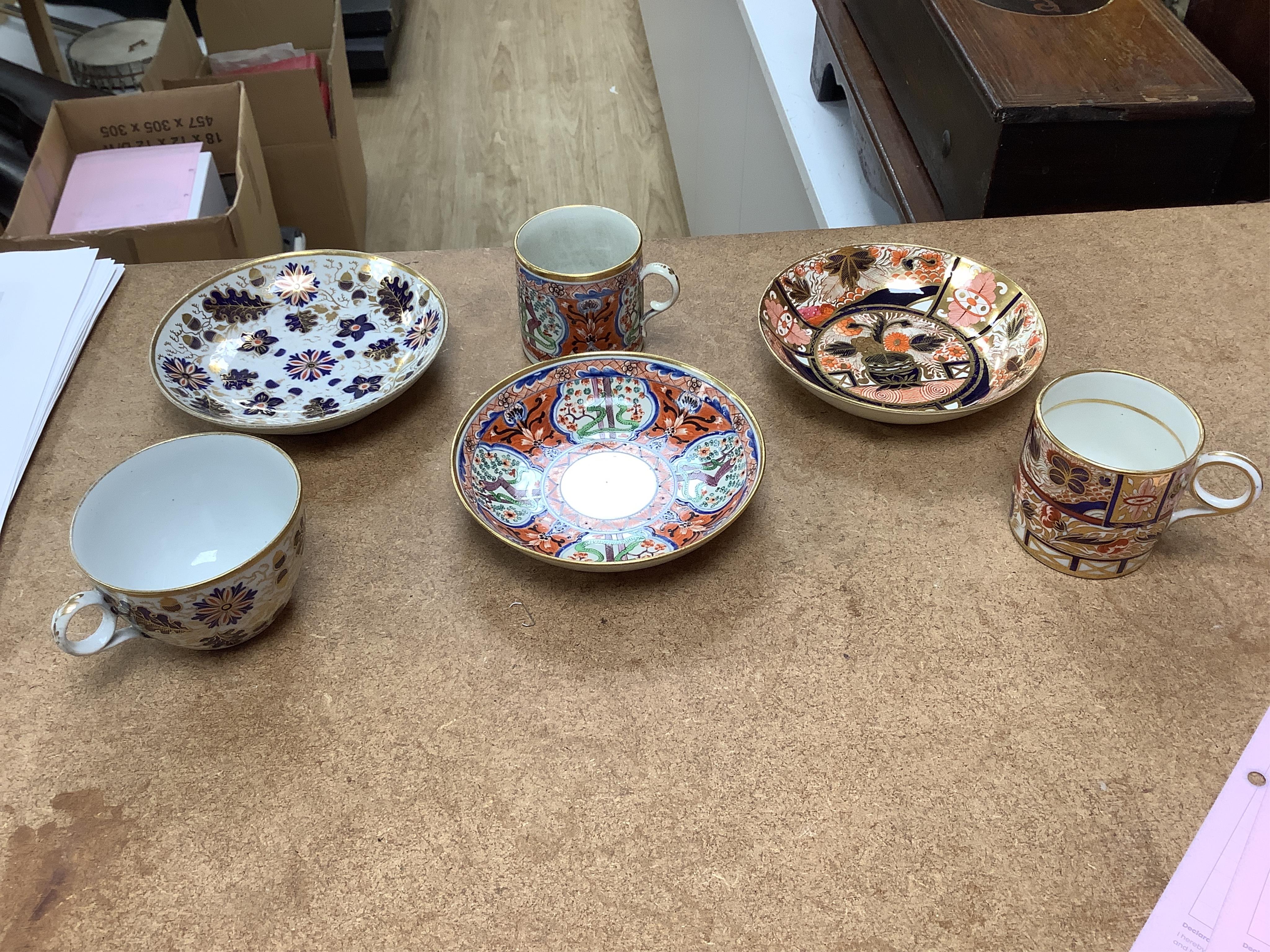 Six mixed English 1800-1820 porcelain cabinet cups and saucers, three similar coffee cans and saucers, a matching spoon stand and two coffee cans, a saucer dish, coffee can plus saucer and a tea bowl and matching saucer